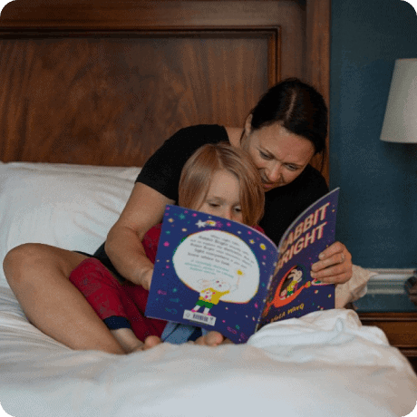 woman reading a story for her kid