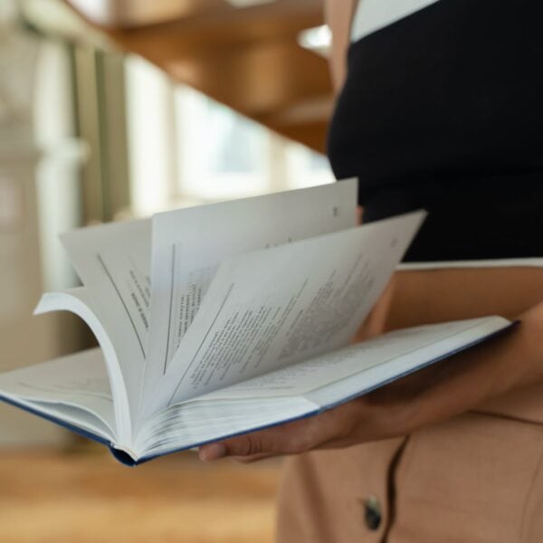 Woman Reading a Book in Close Up Photography